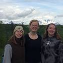 Becca, Hana and Hannah stand in front of Denali Mountain Range.